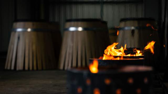 Fûts en chêne en cours de chauffe au feu de bois à la Tonnellerie Remond.